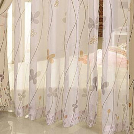 Moderne tyllgardin med stiliserte blomster