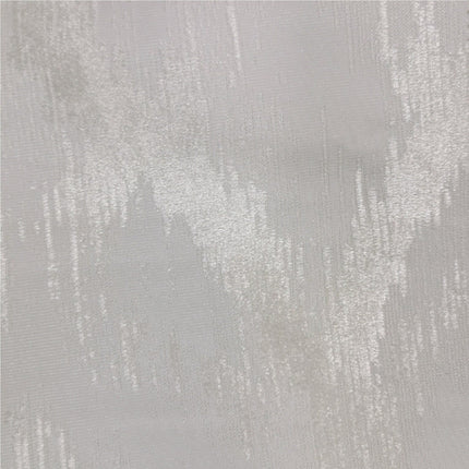 Gråbrun lystett gardin med mønster