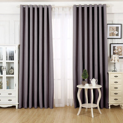 Lystett gardin med maljer grå