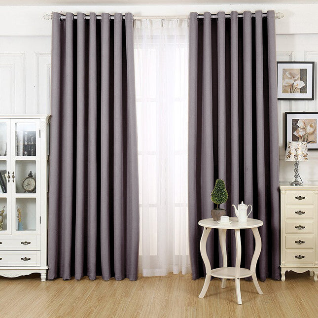 Lystett gardin med maljer grå