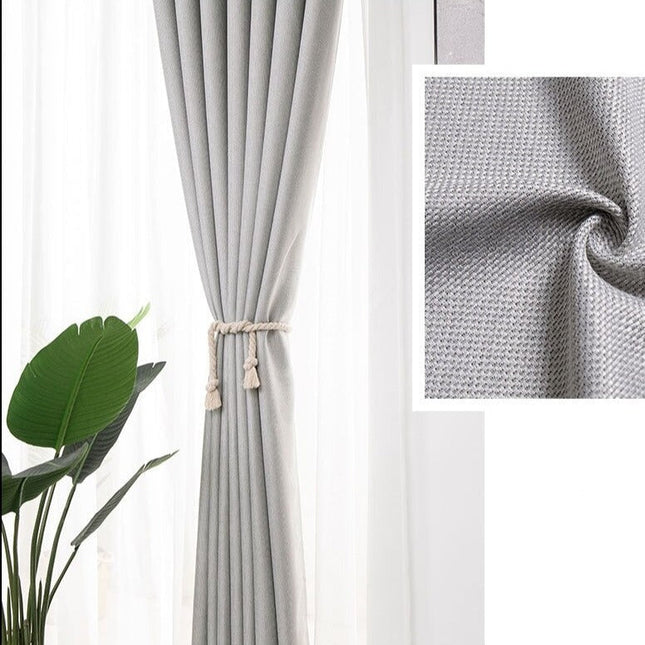 Grå gardin med strukturert vev